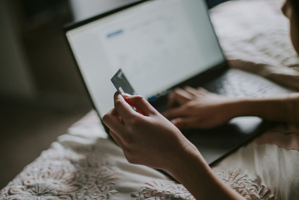 девушка вбивает номер карты на ноутбуке